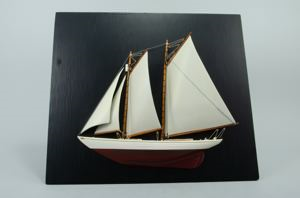 Image: The Schooner Bowdoin in relief on painted black plywood